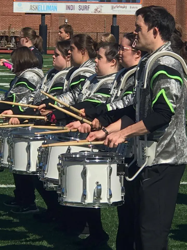 Members of the FREE Players Drum & Bugle Corp in uniform with drums
