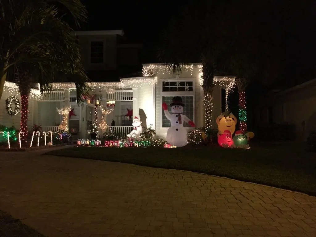 House decorated for Christmas with inflatable snowman and lights