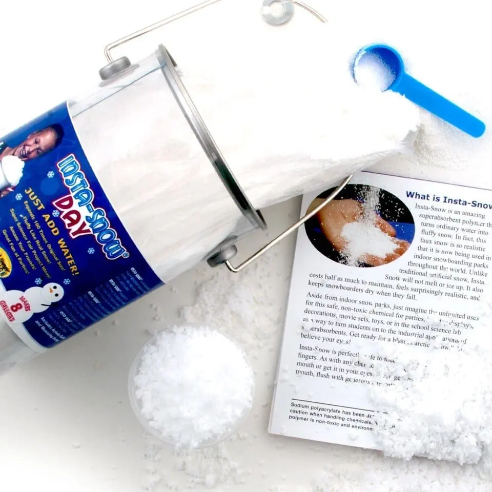 Insta-Snow product with a scoop, instructions, and fake snow.
