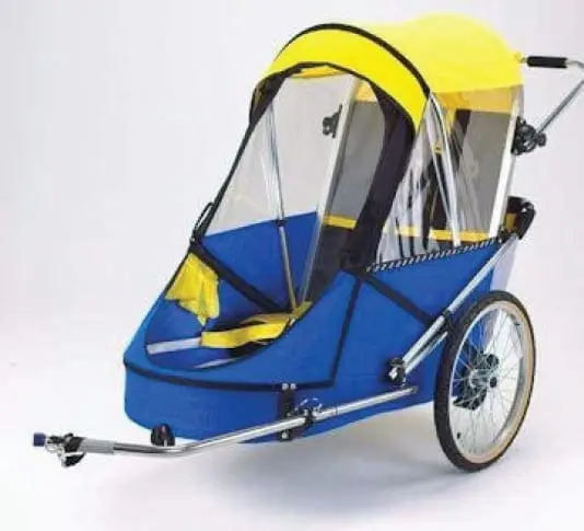 Blue and yellow trailer for special needs children with a clear canopy