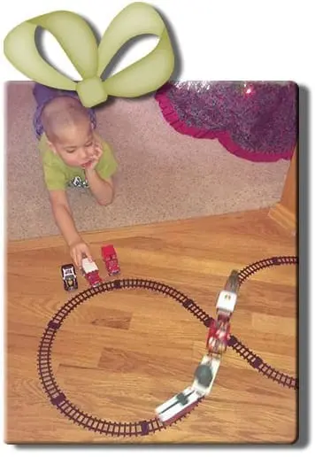 Child playing with a toy train set.