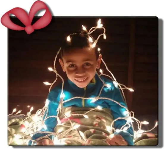 Maria Leticia Present smiling amongst Christmas lights.