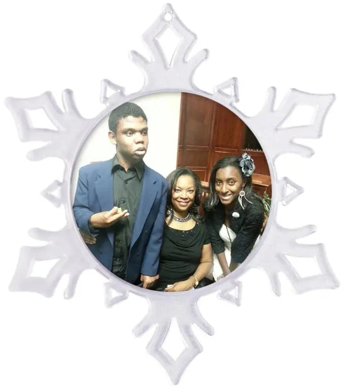 Snowflake ornament with three people inside.