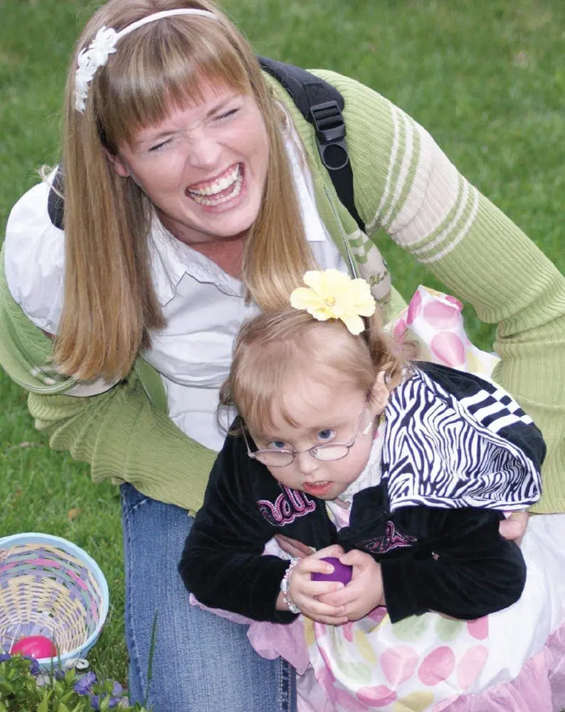 Emarie and Alisha Peters share a joyful moment during an Easter egg hunt.