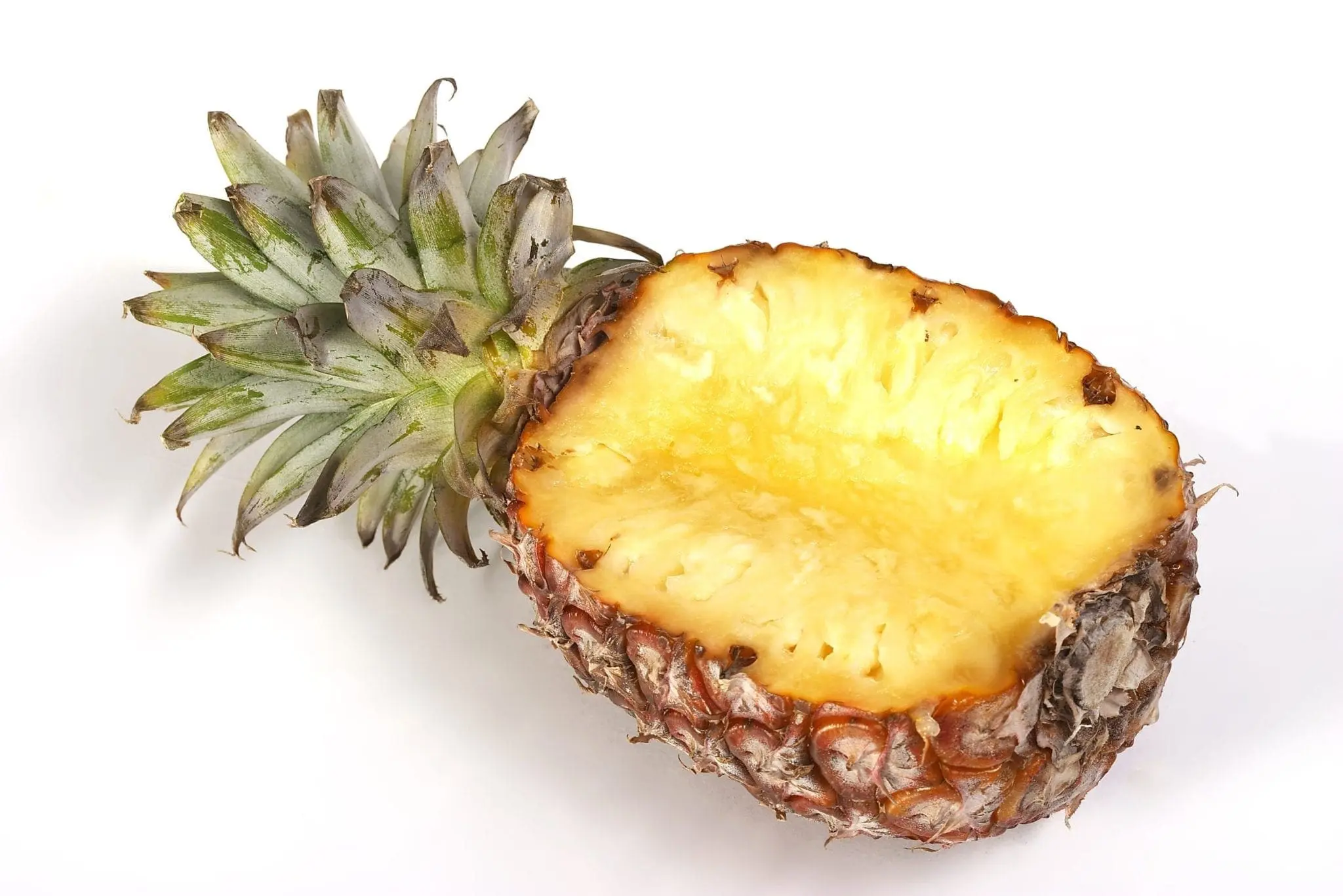 Half of a pineapple with green spiky leaves