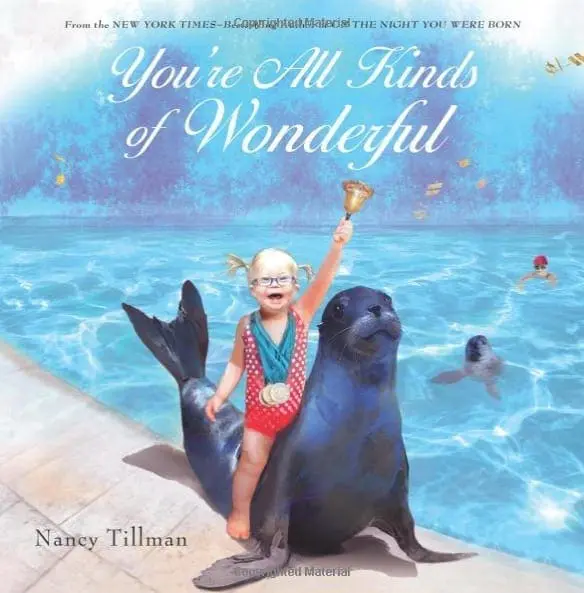 Book cover for You are All Kinds of Wonderful by Nancy Tillman featuring a child holding a bell while sitting on a seal.