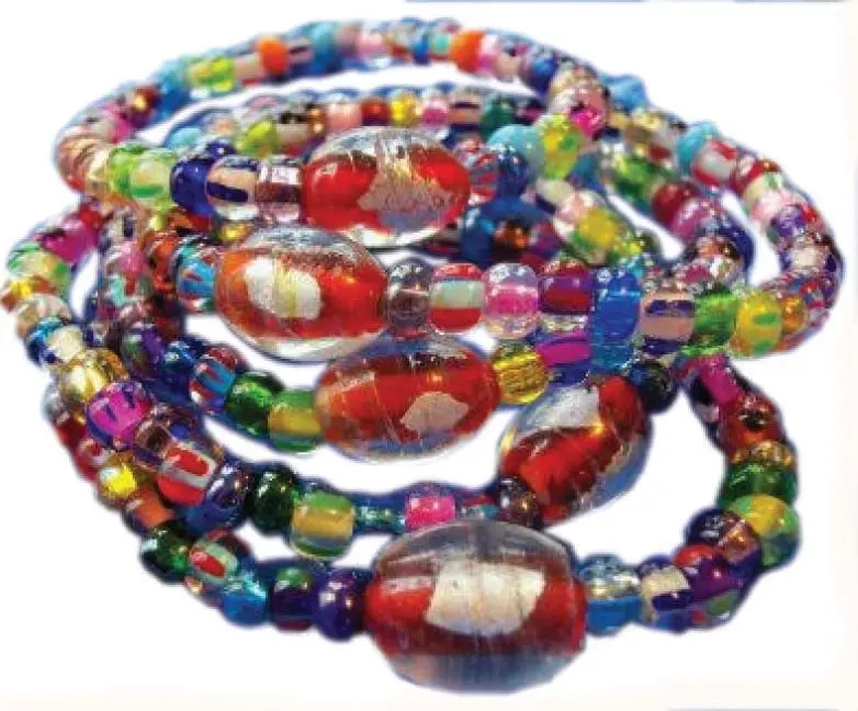Several colorful handmade bracelets with unique oval beads are stacked together.