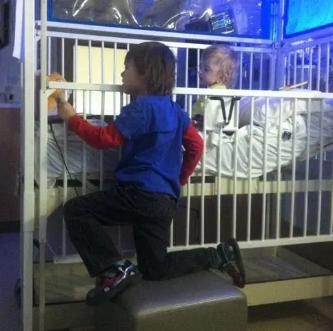Jeffrey and Jax in a hospital crib.