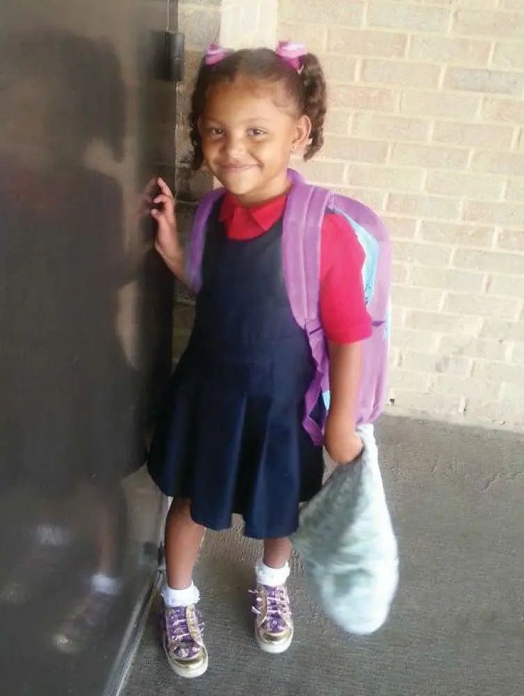 Mariana Pacheco smiling while wearing a school uniform and backpack