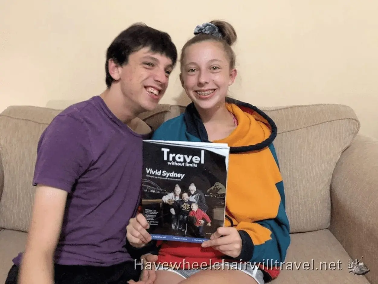BJ and AJ hold a "Travel" magazine featuring Vivid Sydney.