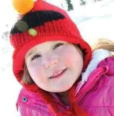 Cheyenne Emily wearing a red knit hat and pink coat.