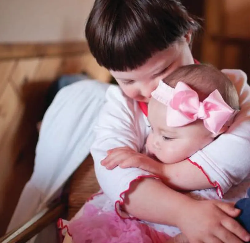 Lauren Hardinger hugs her infant niece.