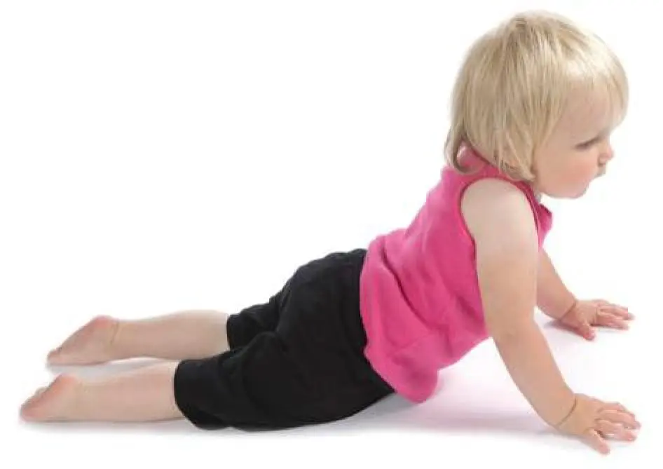 A young child does a yoga pose on a white background.