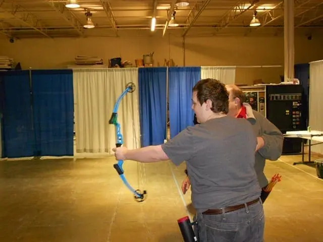 Chris shooting archery with Tom