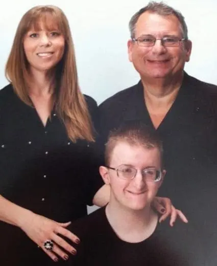 Liz, Mark, and Joey Petruzzi smiling.