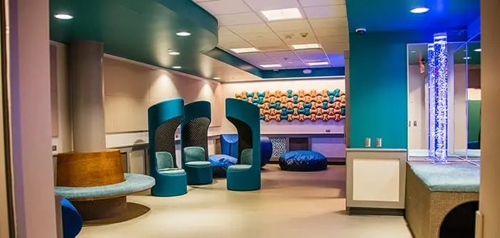Presley's Place sensory room with individual seating pods and a bubble column