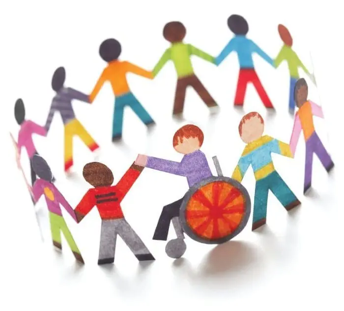 Paper figures of diverse people holding hands in a circle, one in a wheelchair.