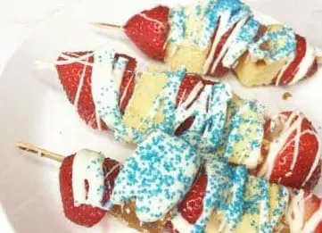 Strawberry poundcake kabobs drizzled with white chocolate and blue sprinkles
