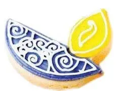 Cookie decorated with blue icing and a yellow lemon slice.