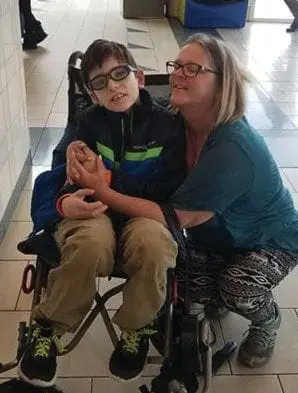 Sandra Cariker with her son Nathan in a wheelchair.