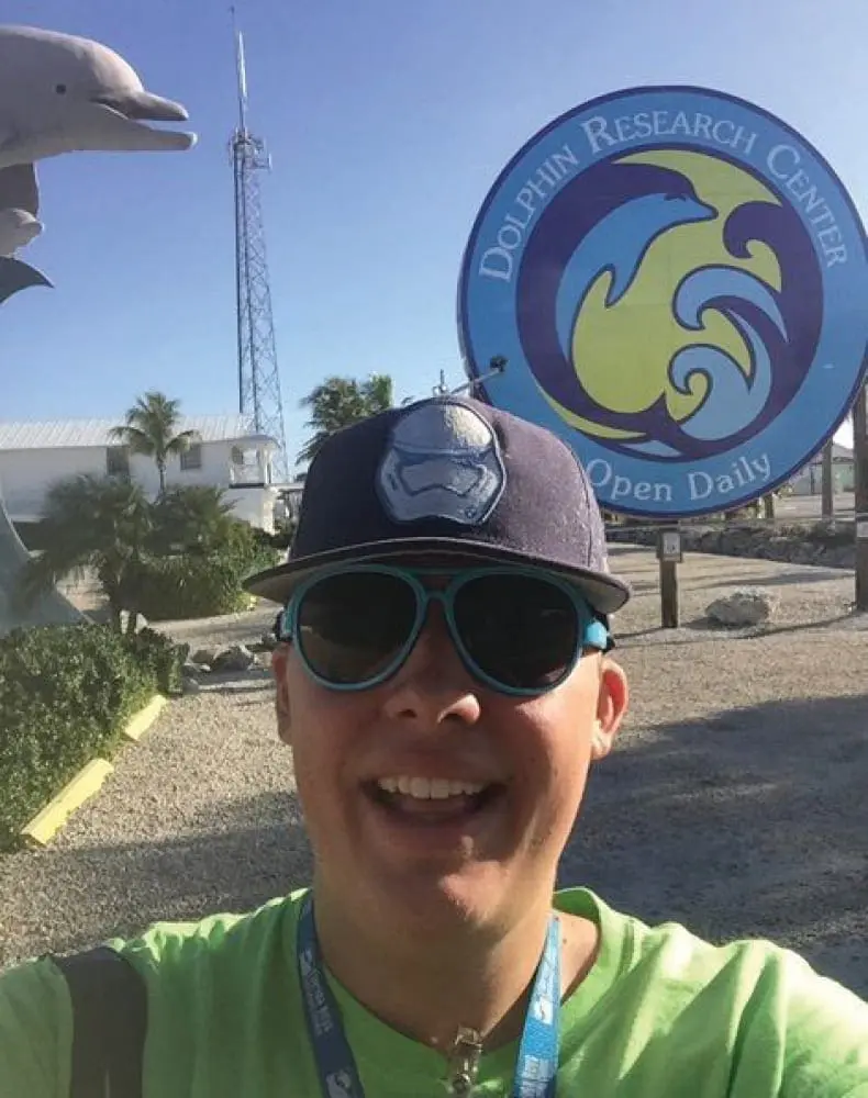 Clayton Pelkey in front of the Dolphin Research Center.