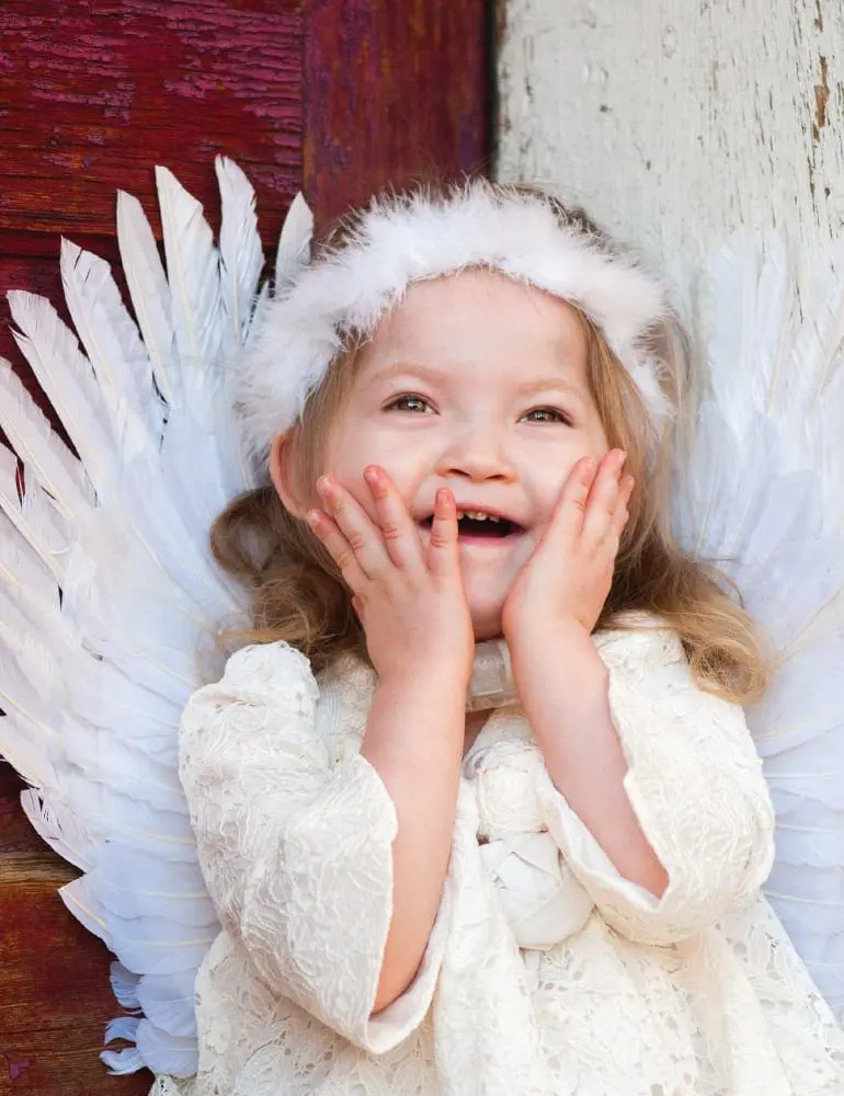 Savannah Rose Richardson with her hands on her cheeks, wearing angel wings.