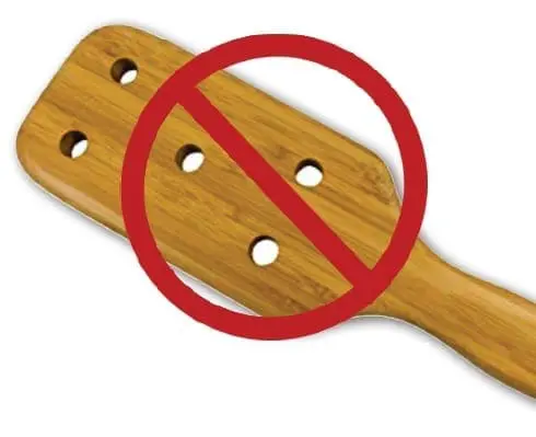 Wooden paddle with a red prohibition sign over it