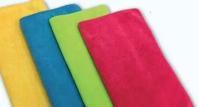 Four colorful folded towels, yellow, blue, green, and pink.