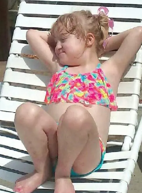 Cecilia Rabe relaxing on a lounge chair outdoors.