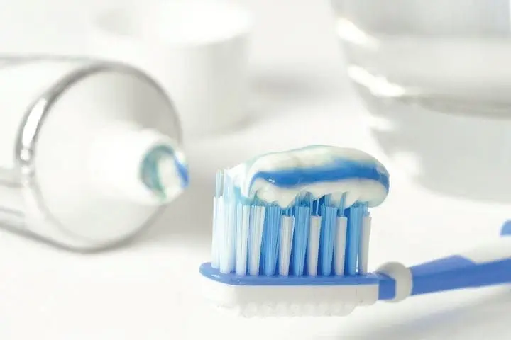 Toothbrush with toothpaste and a tube of toothpaste