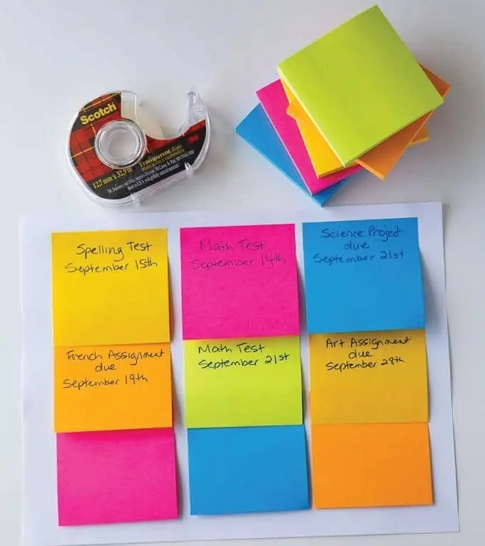 Sticky notes with homework assignments and a roll of tape.