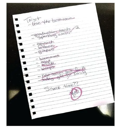 A handwritten shopping list on lined paper.