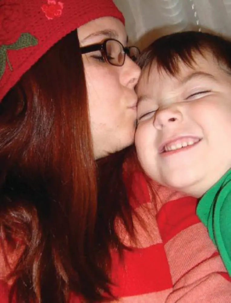 Courtney Barnum kisses Liam on the forehead.