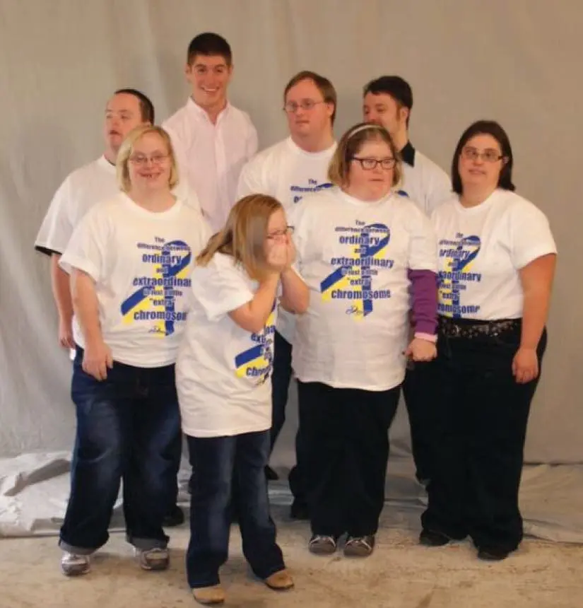 Group of people wearing "Downs Designs Dreams" t-shirts.