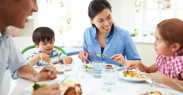 Family enjoying a meal together at a table.