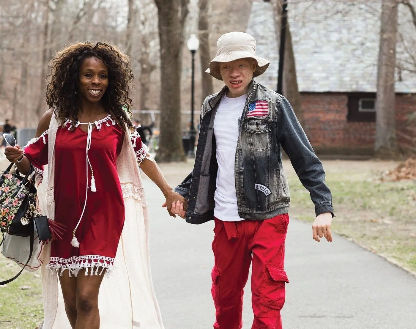 Yomi and Kofi Karade walk hand-in-hand outdoors.