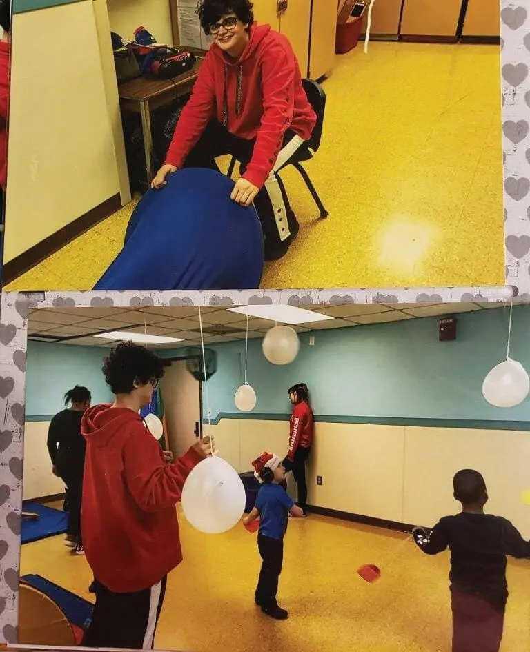Elizabeth in a red hoodie playing with balloons in a room.