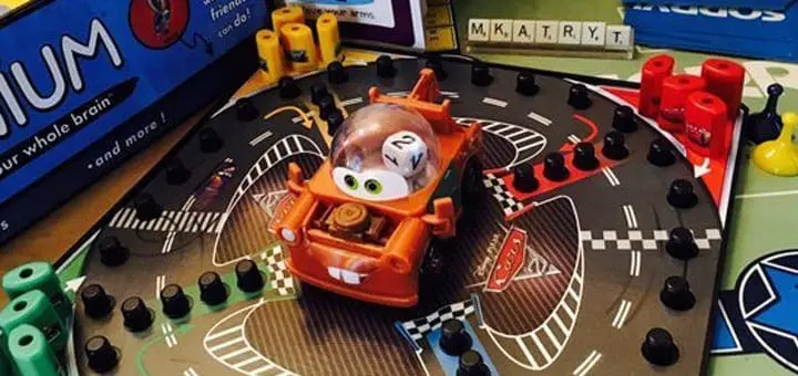 Toy car on a board game representing a race track.