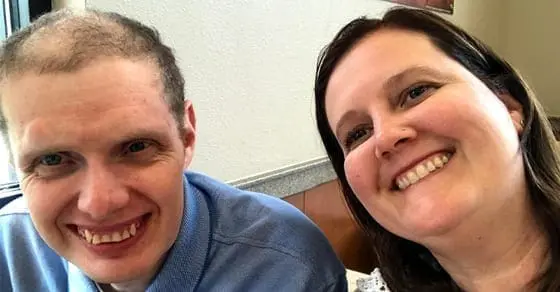 Two people smiling at the camera.