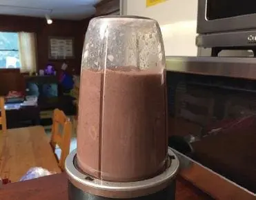 Blender with a chocolate mixture for black bean brownies.