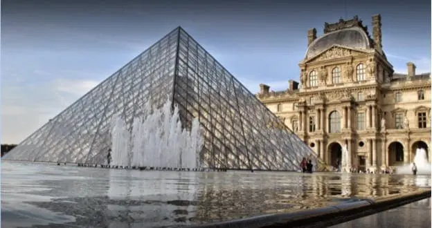 Louvre pyramid and palace with reflections