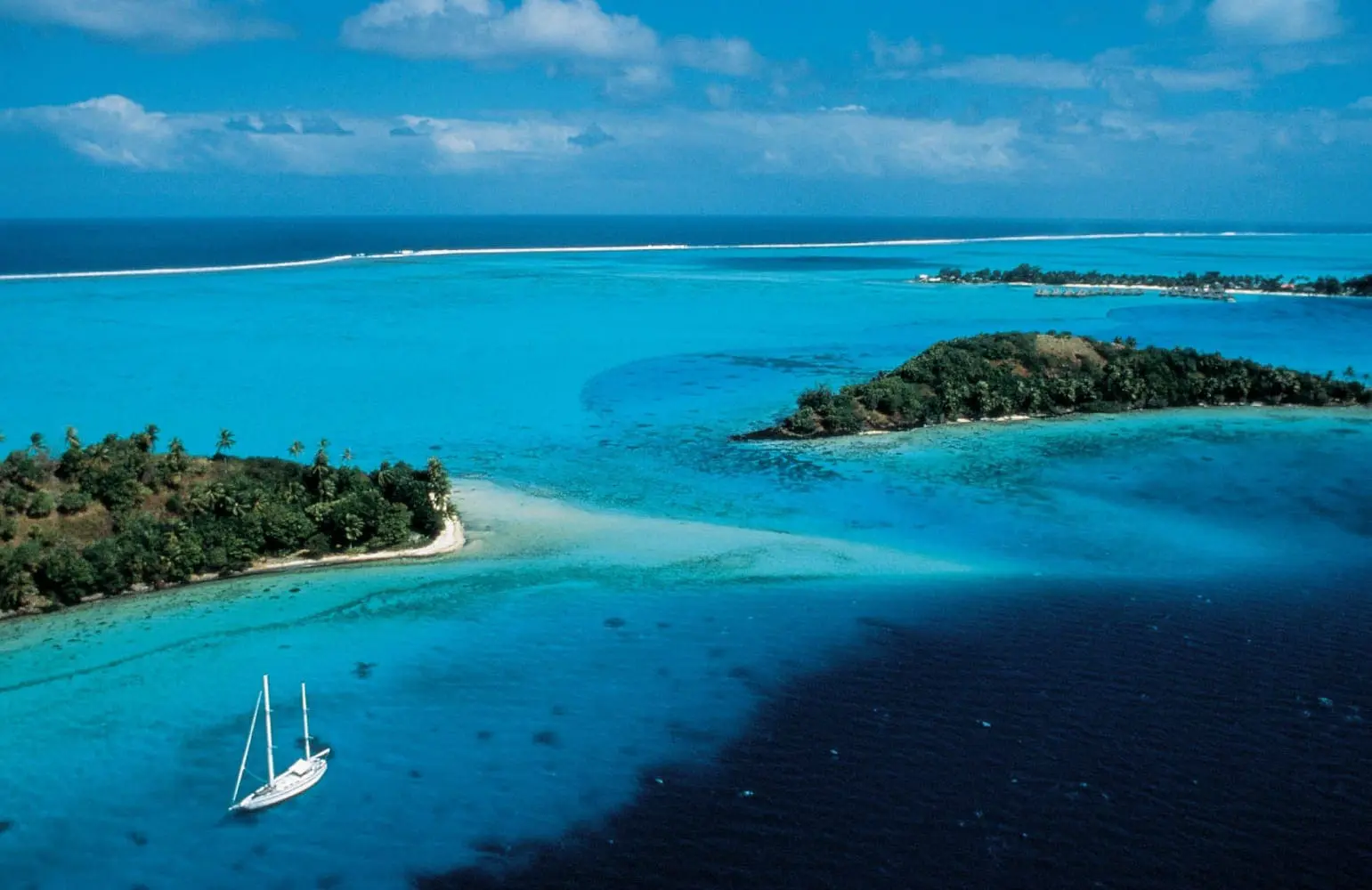 A sailboat in the turquoise waters of Bora Bora.