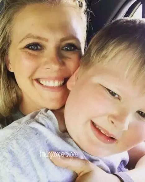 Kate Swenson smiling while holding her son, Cooper.