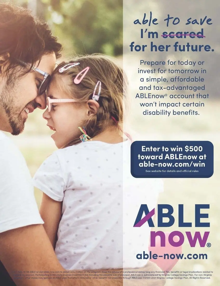 A father holds his daughter, who wears pink glasses and has pink clips in her hair.