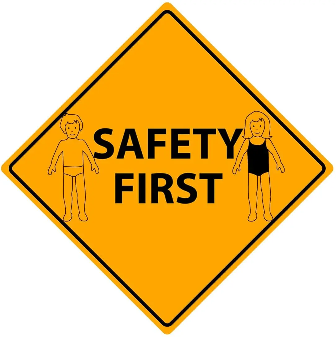 Diamond-shaped yellow sign with black border and text "SAFETY FIRST" with outlines of a boy and a girl on either side.