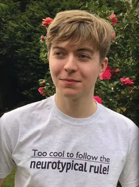 Mikey wearing a t-shirt that says "Too cool to follow the neurotypical rule!