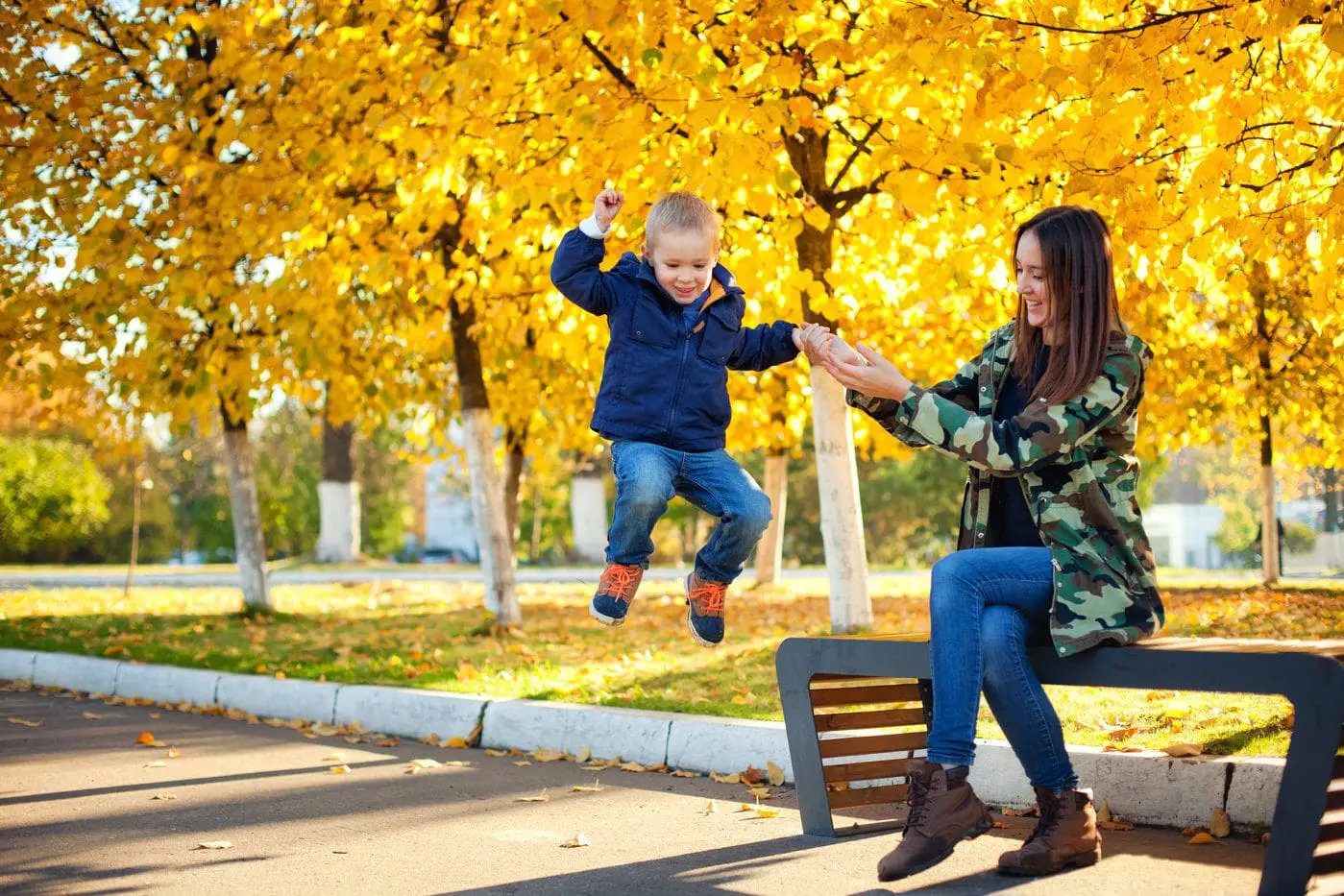 Mother and son playing in an autumn park
