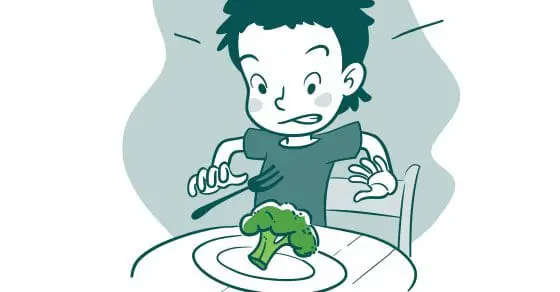 A child with a disgusted expression holds a fork over a piece of broccoli on a plate.