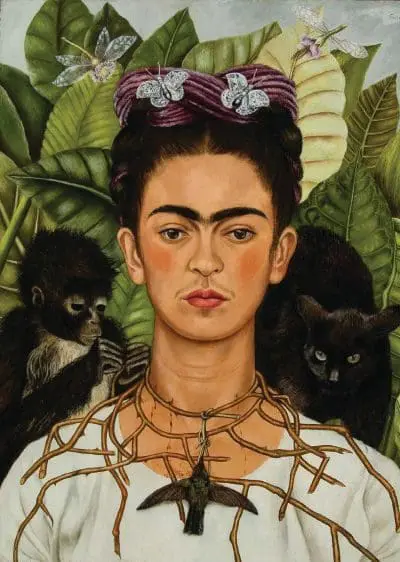 Frida Kahlo with a monkey and a black cat.