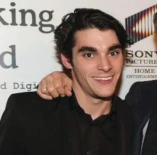 RJ Mitte smiling with his arm around someone's shoulder.